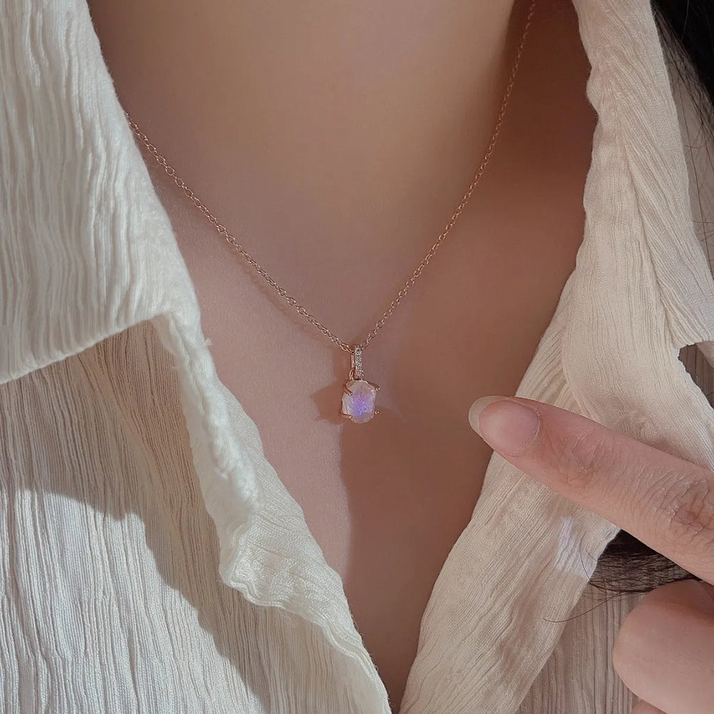Geometric quadrilateral crystal pendant on sterling silver curb chain necklace with rose gold or platinum plating options.