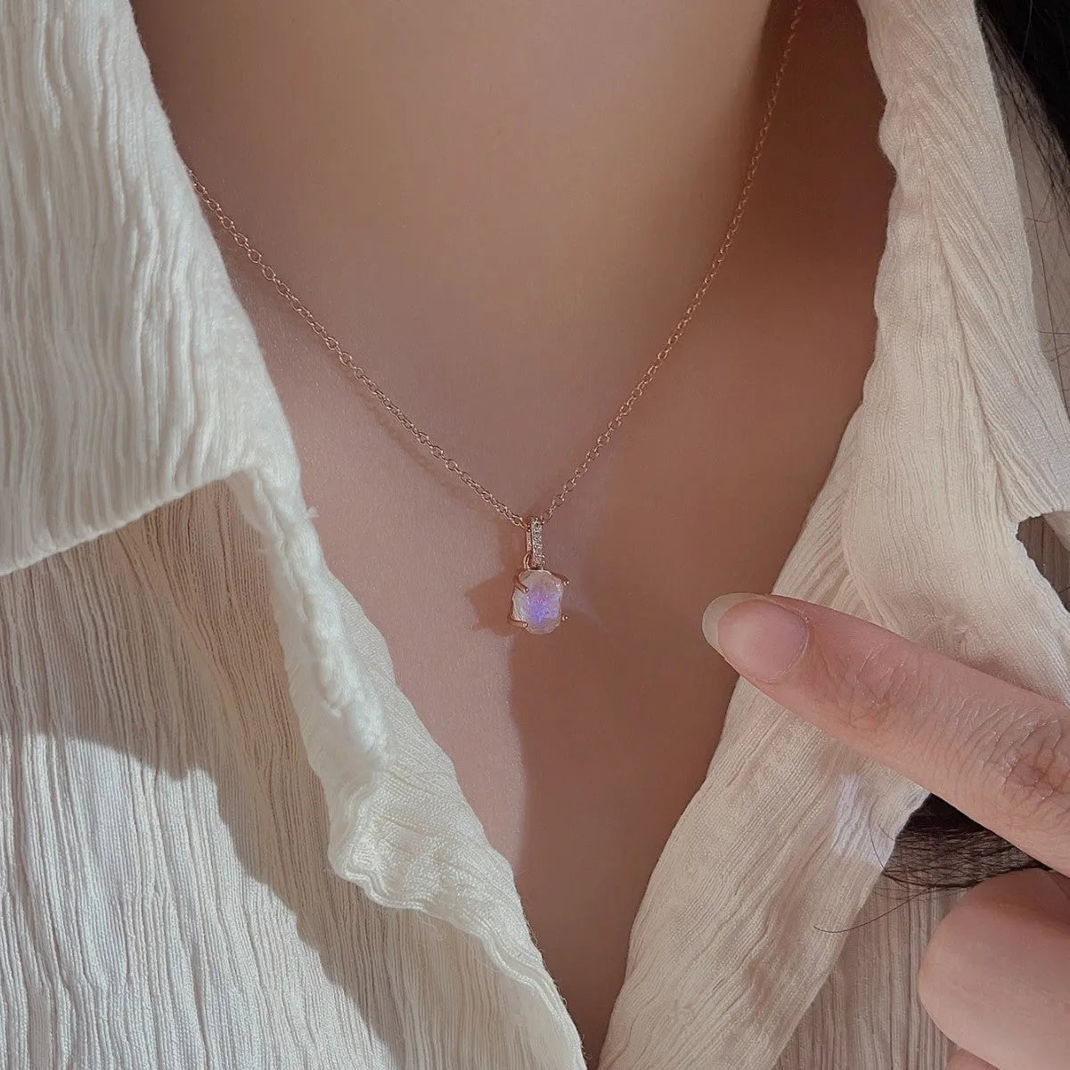 Geometric quadrilateral crystal pendant on sterling silver curb chain necklace with rose gold or platinum plating options.