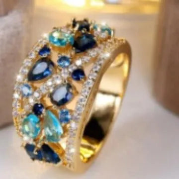 Women's copper hollow round fashion ring in gold or platinum with white or blue accent, shown on a hand.