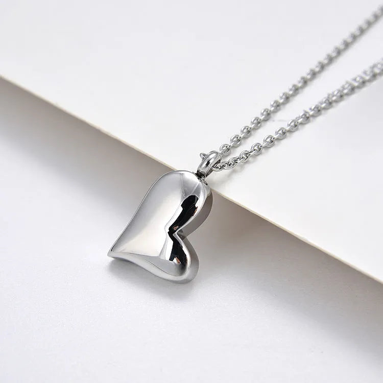 Curved peach heart stainless steel pendant necklace with silver electroplated finish on 51cm chain
