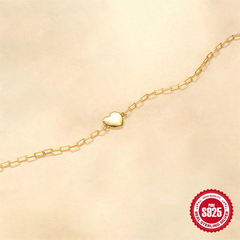 Gold-colour sterling silver bracelet with heart charm and clip chain fastening