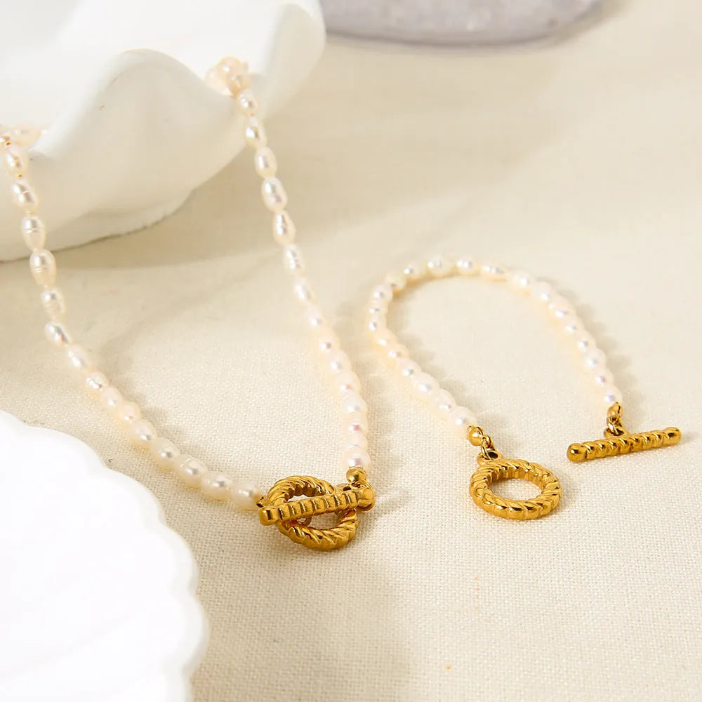 Freshwater pearl and stainless steel necklace bracelet set with geometric shapes on clavicle chain