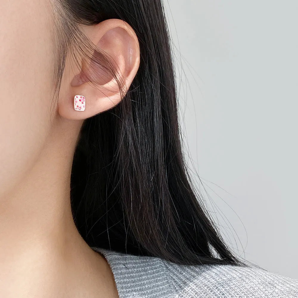 S925 sterling silver cherry blossom square stud earrings on a white background, showing polished silver finish and floral geometric design.