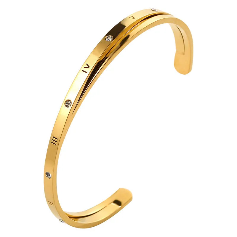Open-ended adjustable ladies bracelet in stainless steel with zircon detailing showing gold colour finish