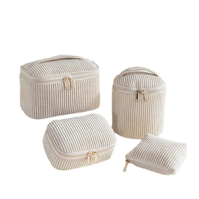 Four cube style makeup bags in different colour patterns including pink, khaki, and dotted designs
