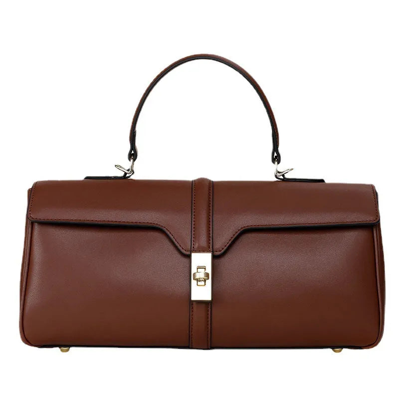 Women's genuine cowhide messenger bag in cylindrical shape with internal organisers