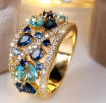 Women's copper hollow round fashion ring in gold or platinum with white or blue accent, shown on a hand.