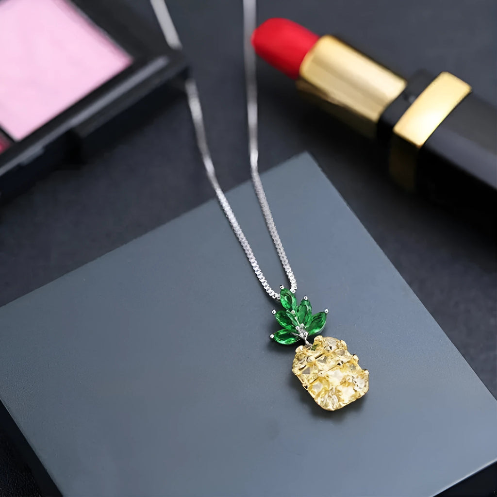 Silver geometric pineapple pendant necklace with diamond details on a model.