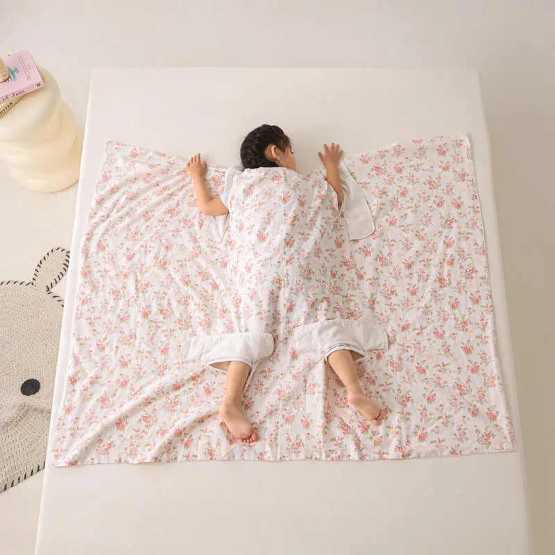 Patterned anti-kick sleeping bag blanket laid flat on a bed, showing its quilted texture.
