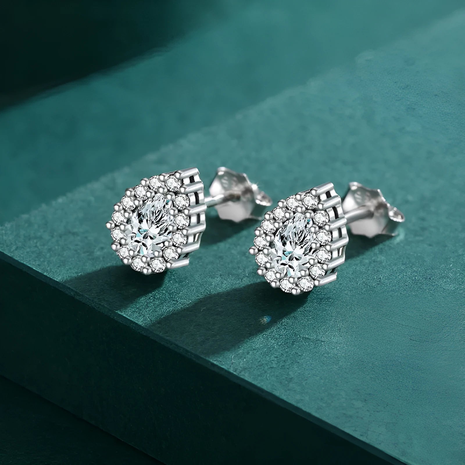 Women's silver drop ear studs with 925 sterling silver construction and diamond treatment finish