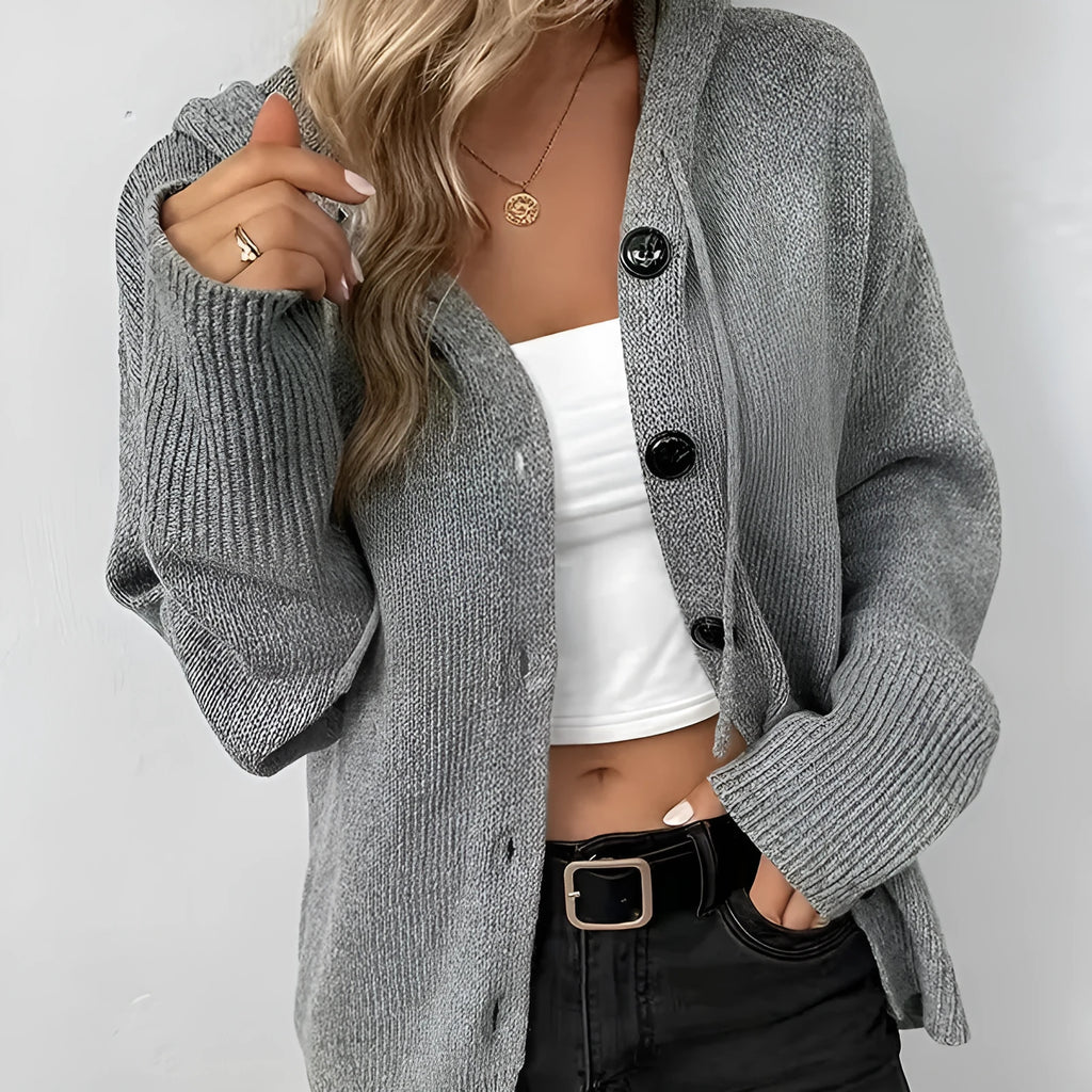A solid colour hooded cotton cardigan sweater shown in a loose fit on a model.