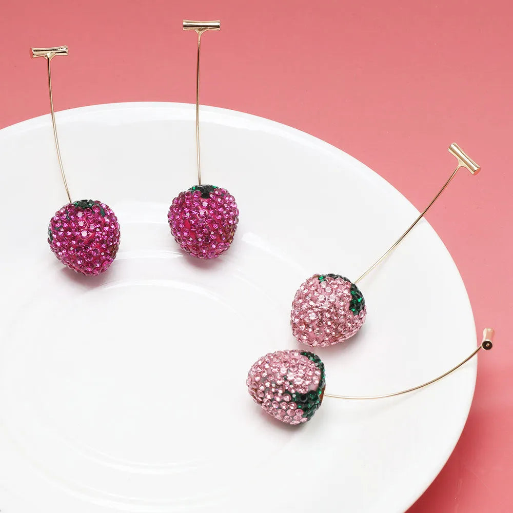 Geometric zinc alloy women's earrings with a red strawberry charm on a white background.