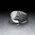 Silver geometric wolf head ring for men on a grey background.