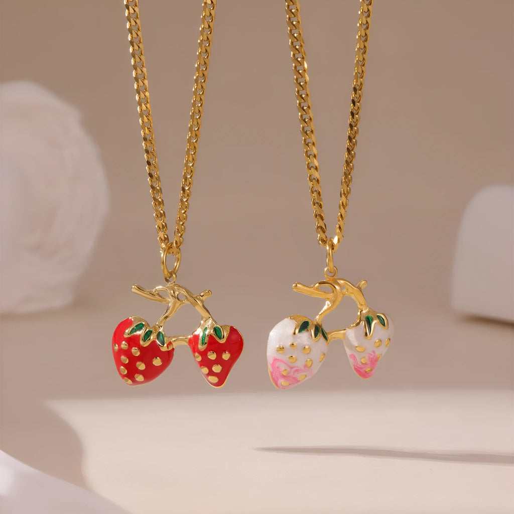 Alloy strawberry fruit pendant necklace on stainless steel chain with red charm and white gradient background.