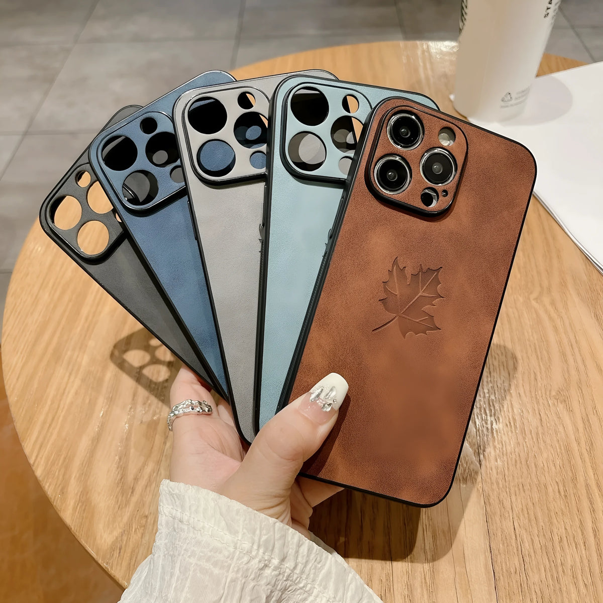 Skin feeling lambskin maple leaf phone case in blue for iPhone 17 with silicone protection