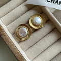 A pair of round gold electroplated earrings with a French retro simple style for women.
