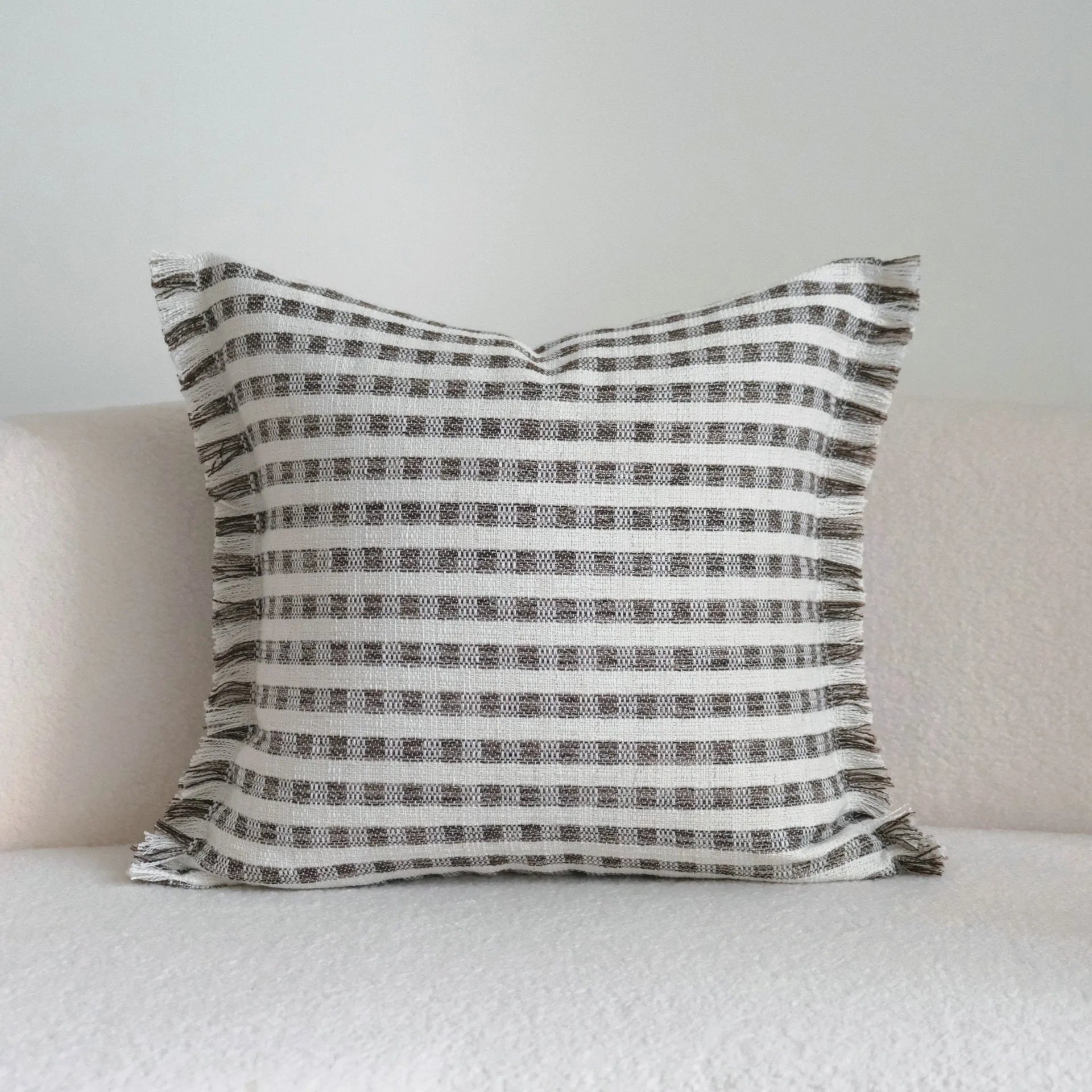 Coffee brown mid-century modern striped cushion on a sofa, showing 30x50cm and 45x45cm size options.