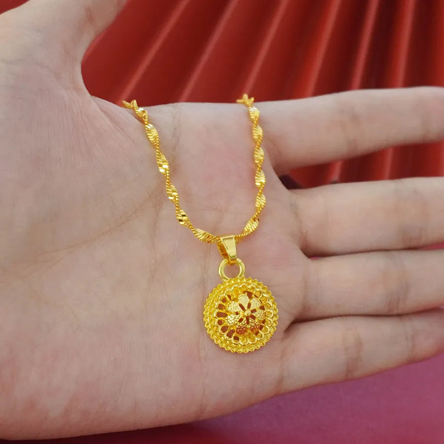 Gold-plated women's three-piece jewelry set showing necklace with floral pendant, matching earrings, and ring