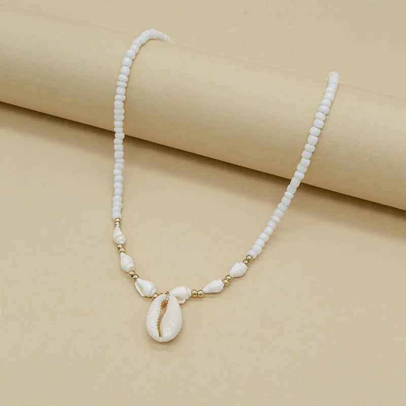 White conch bead necklace with a mother-of-pearl shell pendant on a regular chain