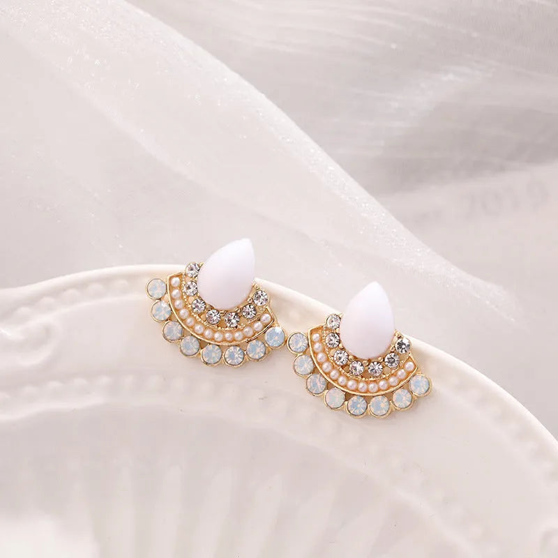 Women's retro fan-shaped silver stud earrings with rhinestones on a geometric alloy design.