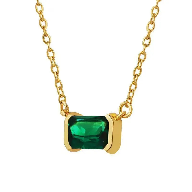 Gold geometric quadrilateral pendant necklace with inlaid cubic zirconia stones on a chain.