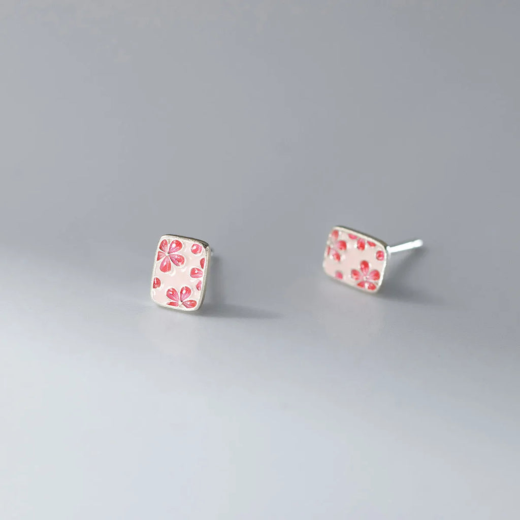 S925 sterling silver cherry blossom square stud earrings on a white background, showing polished silver finish and floral geometric design.