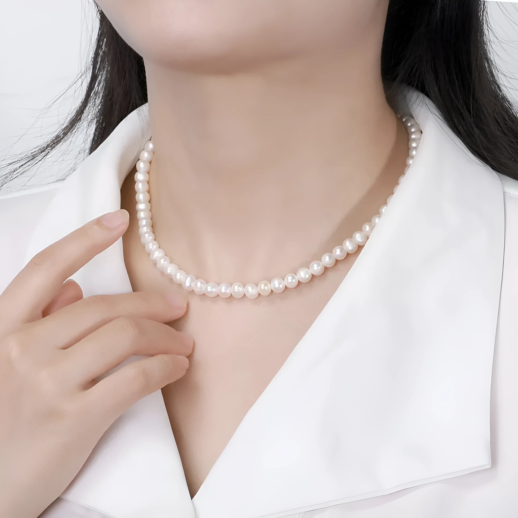 Women's silver adjustable chain necklace with a single natural freshwater pearl.
