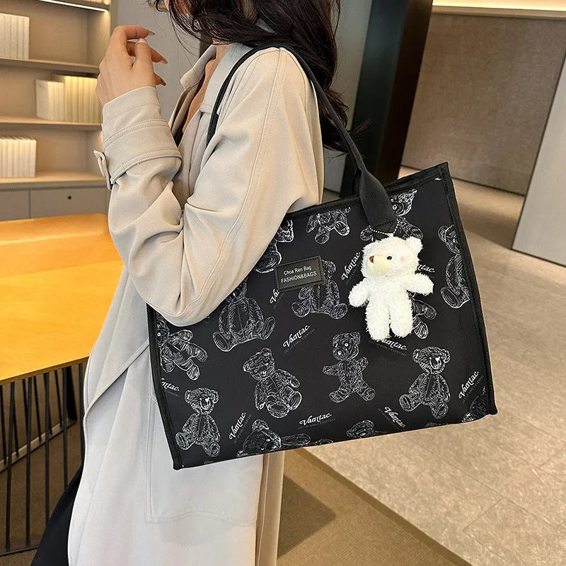 Women's black and white printed canvas tote bag showing rhombus pattern and sandwich pocket.