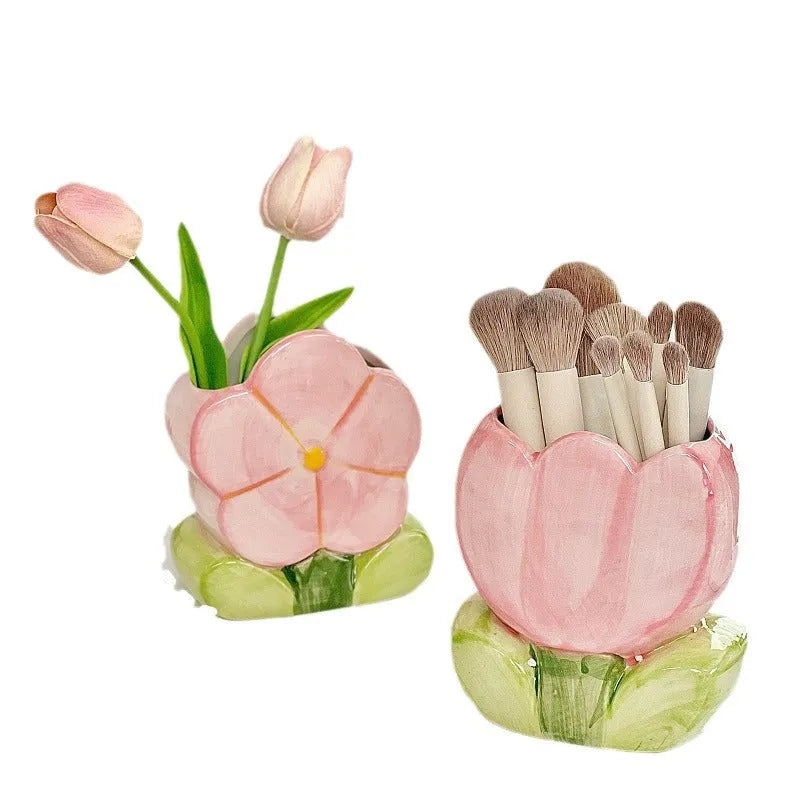 Ceramic tulip-shaped pen holder and storage box in a floral colour pattern on a desk.
