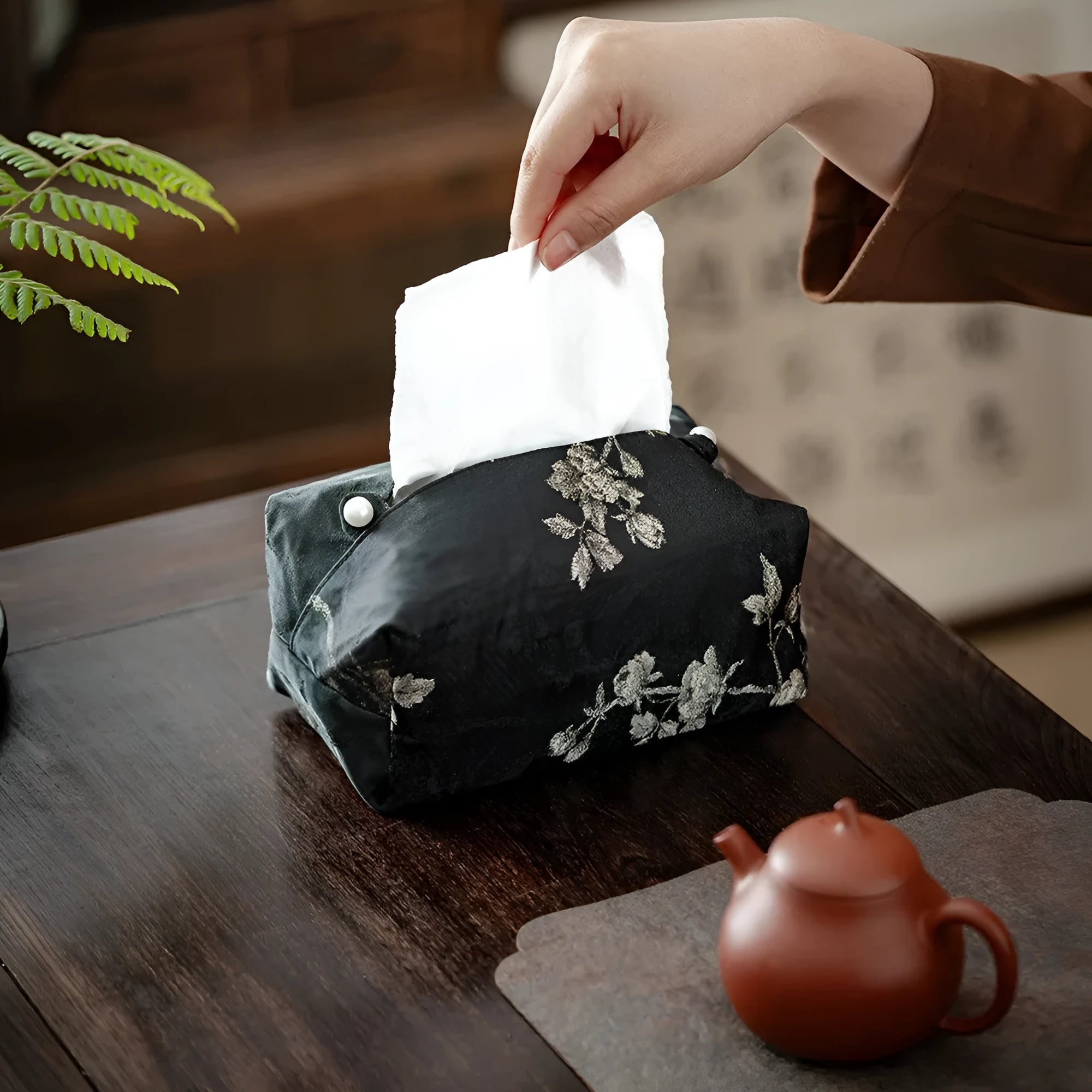 White embroidered Chinese brocade fabric tissue box with optional pearl buckle, shown on a table.