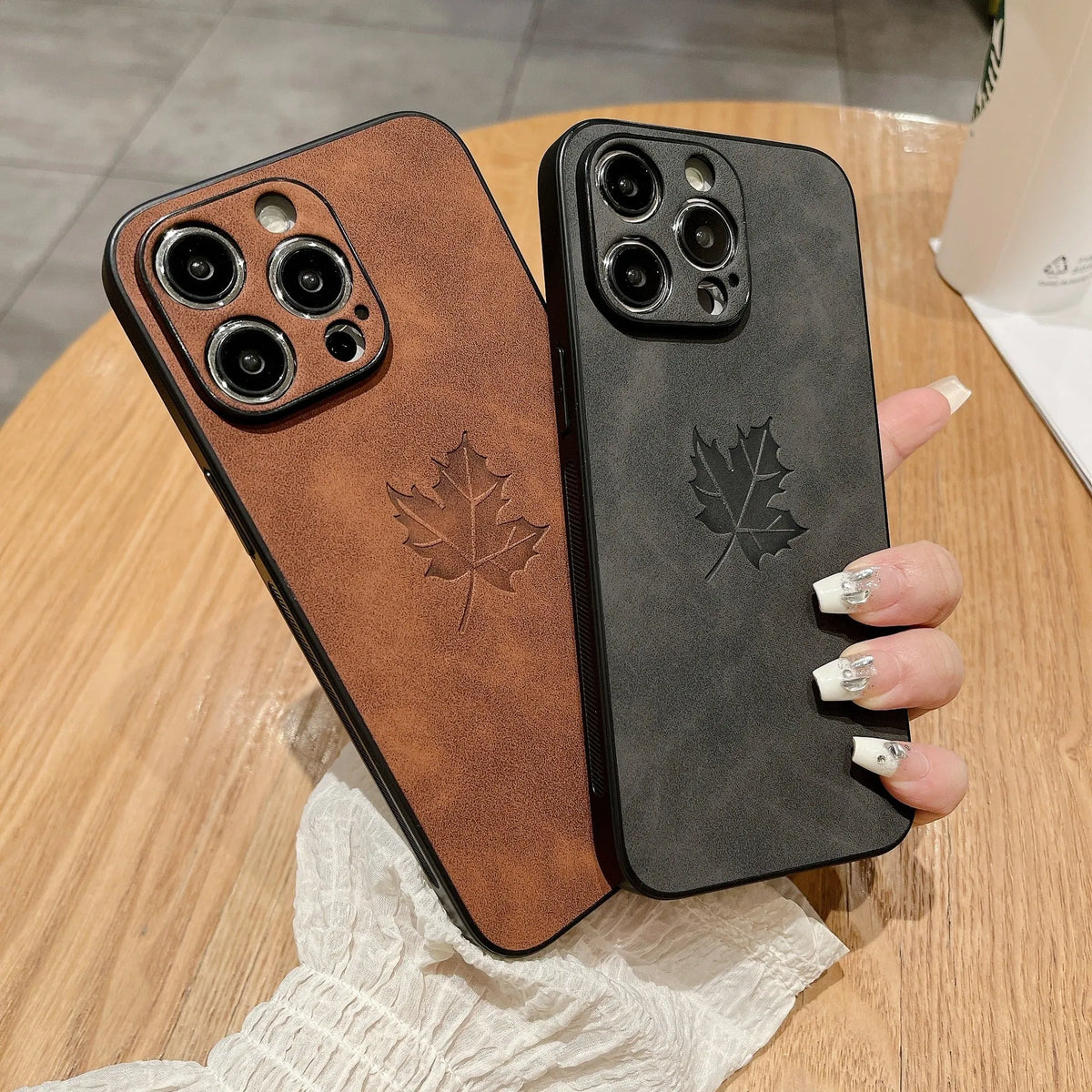 Skin feeling lambskin maple leaf phone case in blue for iPhone 17 with silicone protection