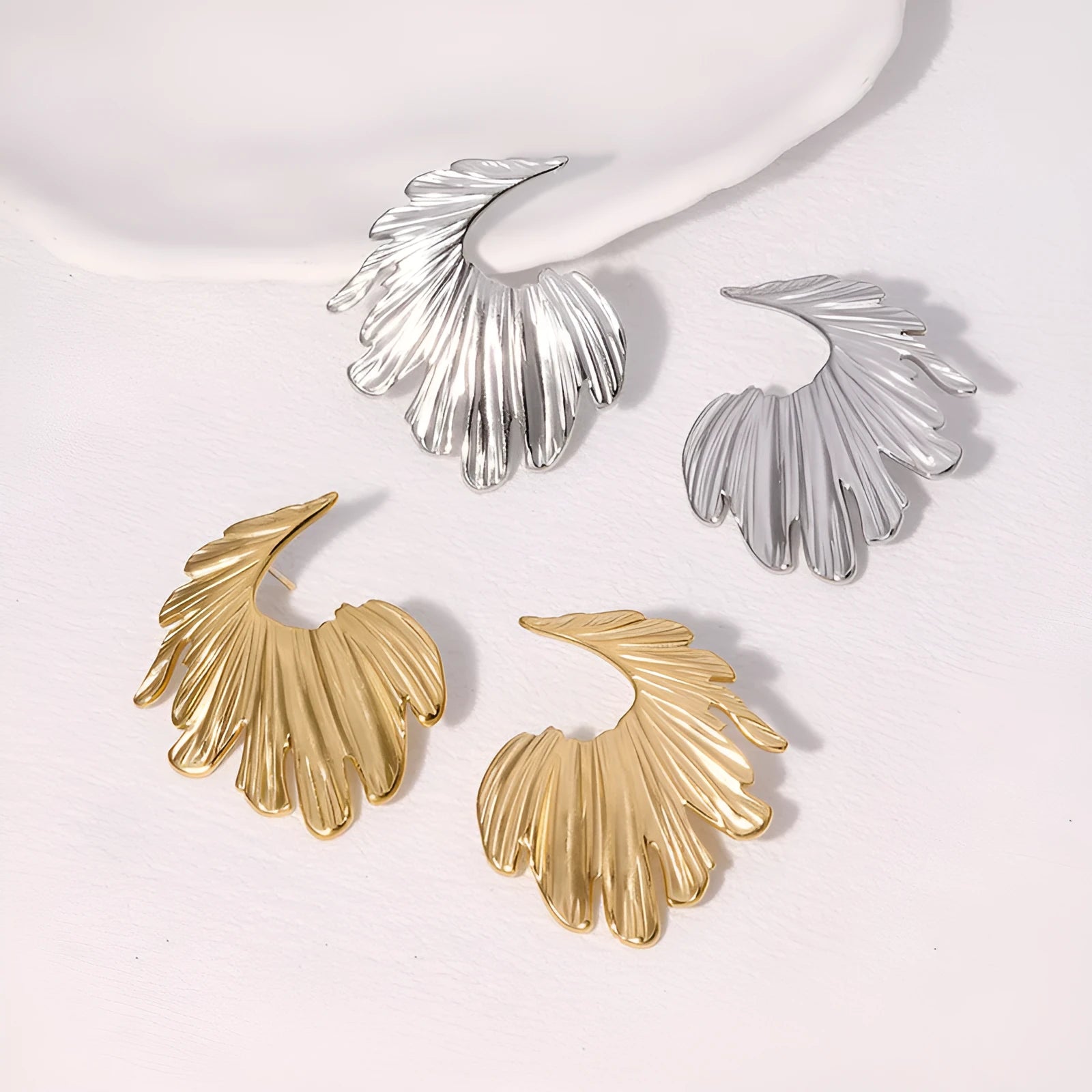 Stainless steel leaf stud earrings in gold and steel colour options