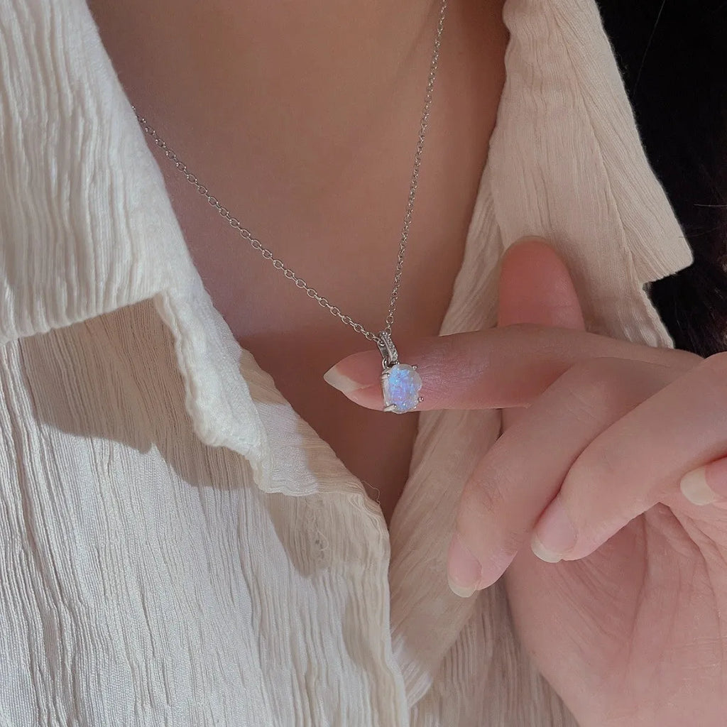 Geometric quadrilateral crystal pendant on sterling silver curb chain necklace with rose gold or platinum plating options.