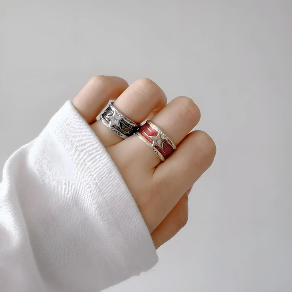 Women's adjustable copper ring with distressed XINGX drop oil design in geometric shape showing colour options