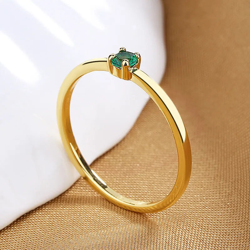 Geometric copper women's ring with a single diamond, shown in blue, green, red, and white colour variations.