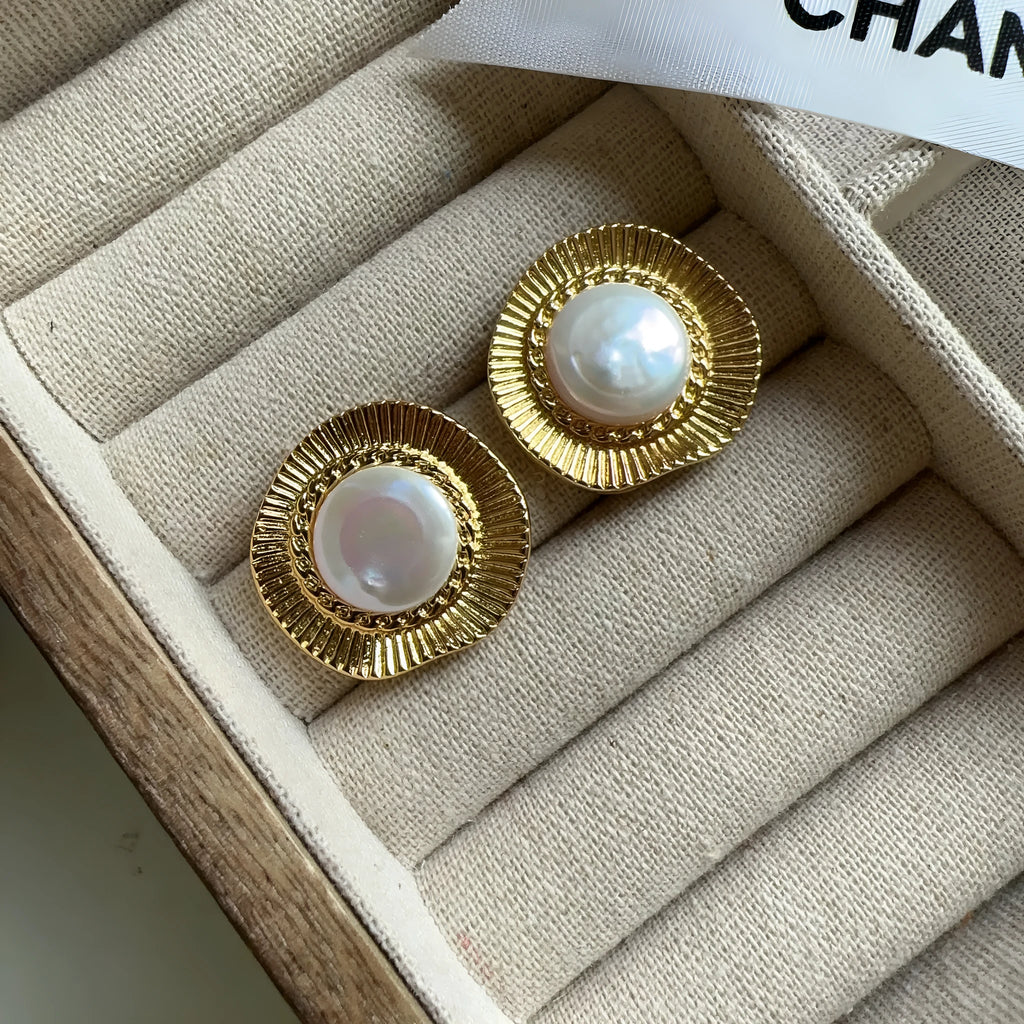 A pair of round gold electroplated earrings with a French retro simple style for women.