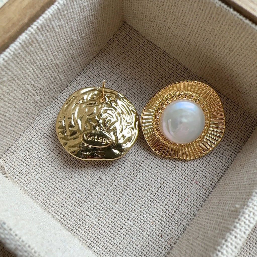 A pair of round gold electroplated earrings with a French retro simple style for women.