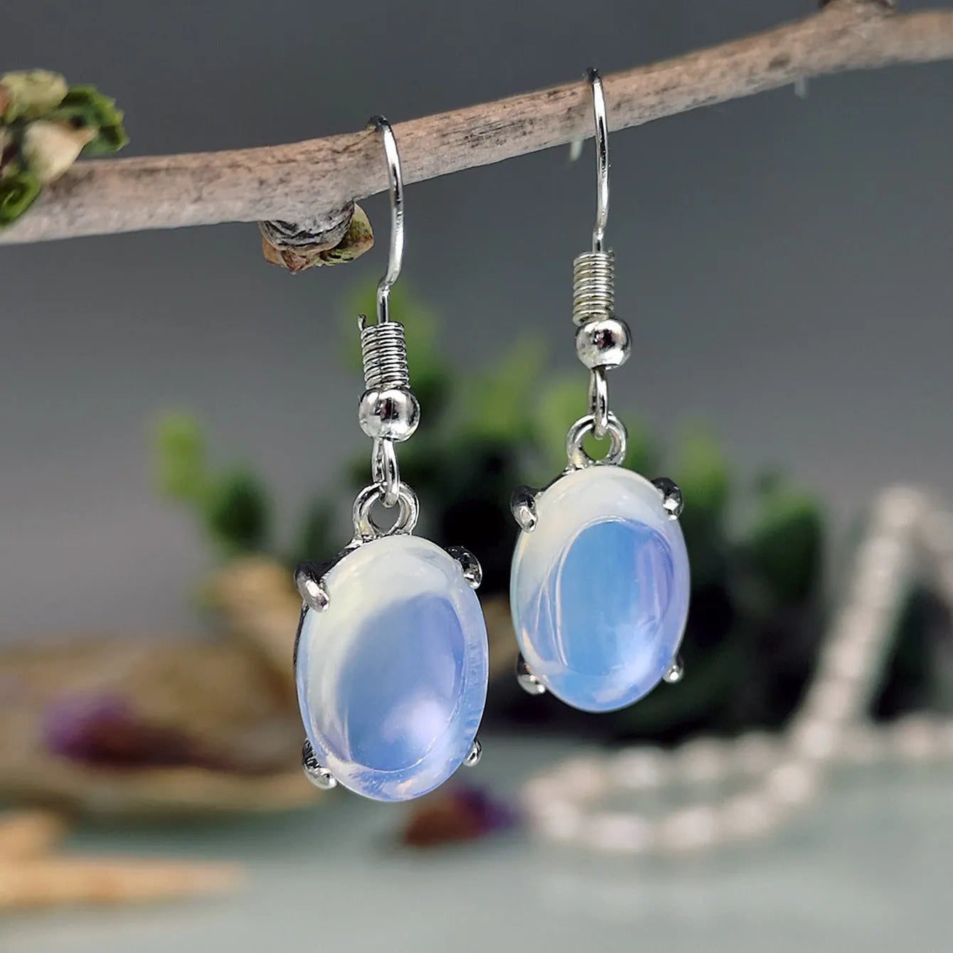 Moonlight white opal drop earrings with retro cross detail and electroplated finish