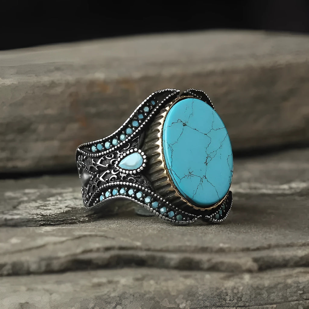 Men's round turquoise alloy ring with antique silver finish shown on finger