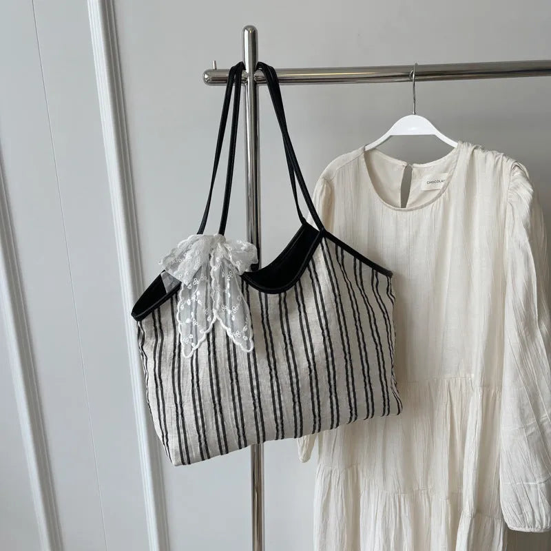 Striped cloth Korean style bucket shoulder messenger bag with beige ribbon scarf and woven belt detailing, soft horizontal square shape