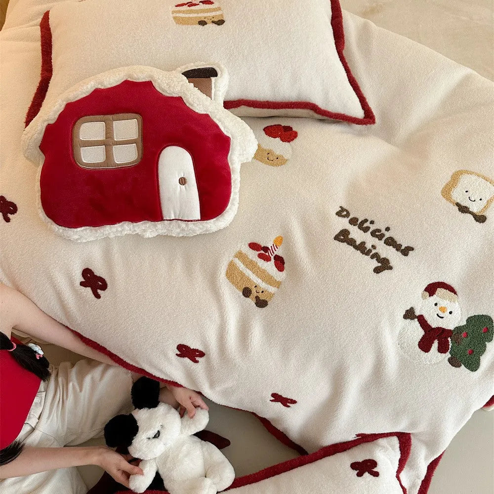 Girl's winter cartoon print bedding four-piece set with bed sheet, duvet cover, and pillowcases on a bed.
