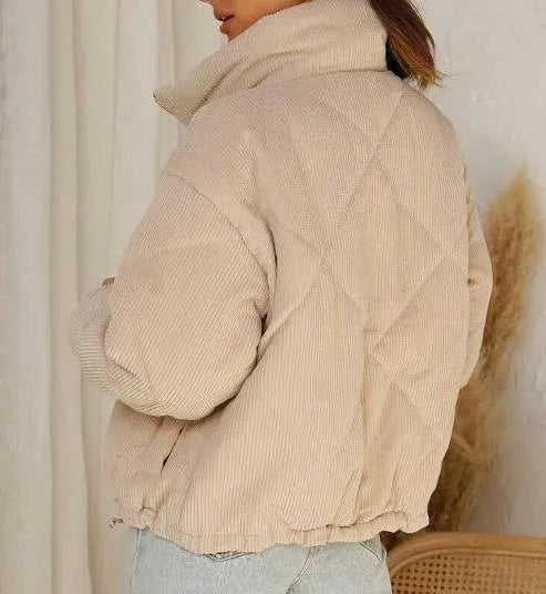 Apricot coloured women's corduroy jacket with a stand collar, front zipper, and long sleeves.
