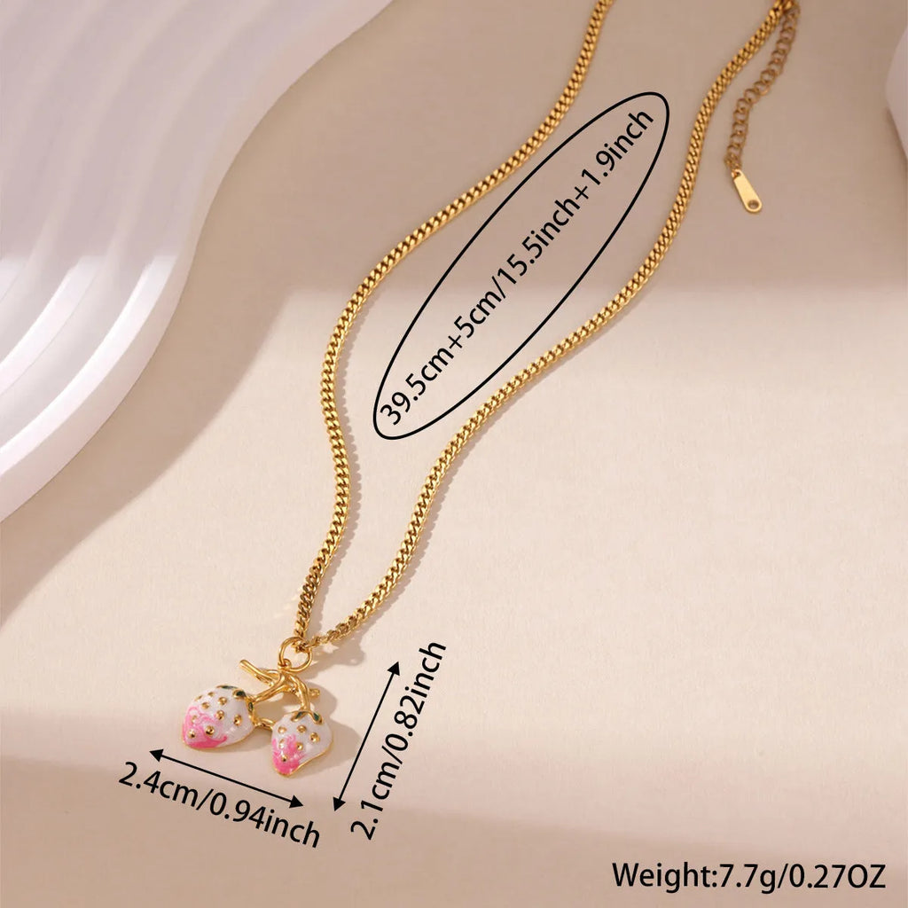 Alloy strawberry fruit pendant necklace on stainless steel chain with red charm and white gradient background.