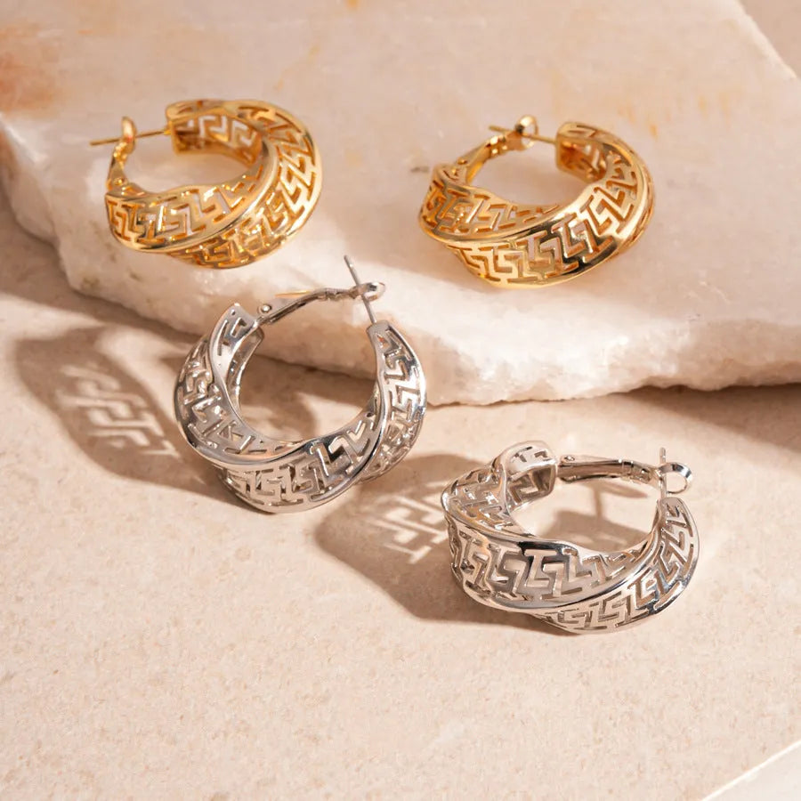 Geometric women's hollow stud earrings in gold or silver with exaggerated twisted round design
