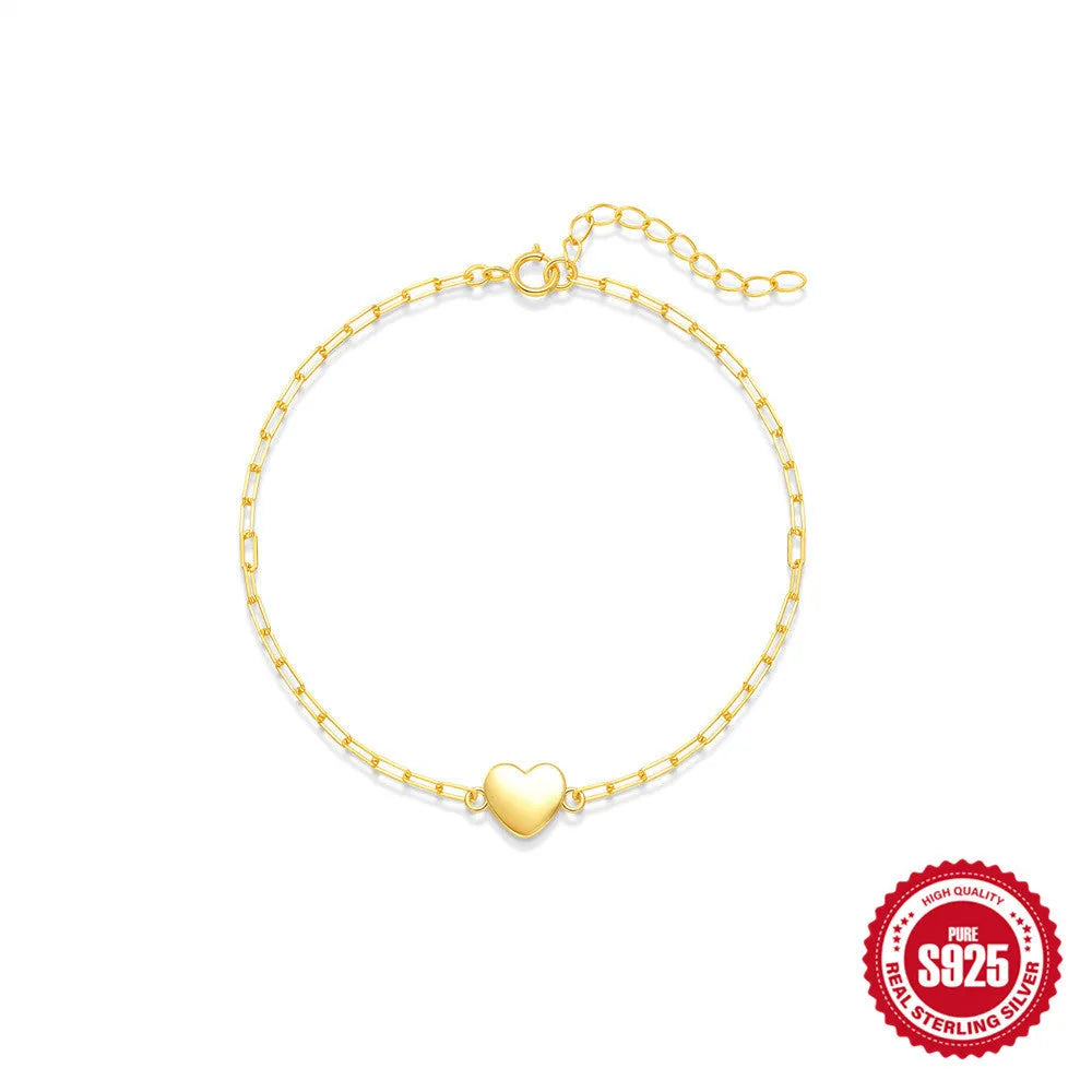 Gold-colour sterling silver bracelet with heart charm and clip chain fastening
