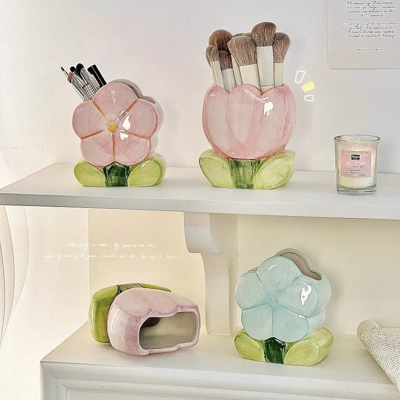 Ceramic tulip-shaped pen holder and storage box in a floral colour pattern on a desk.