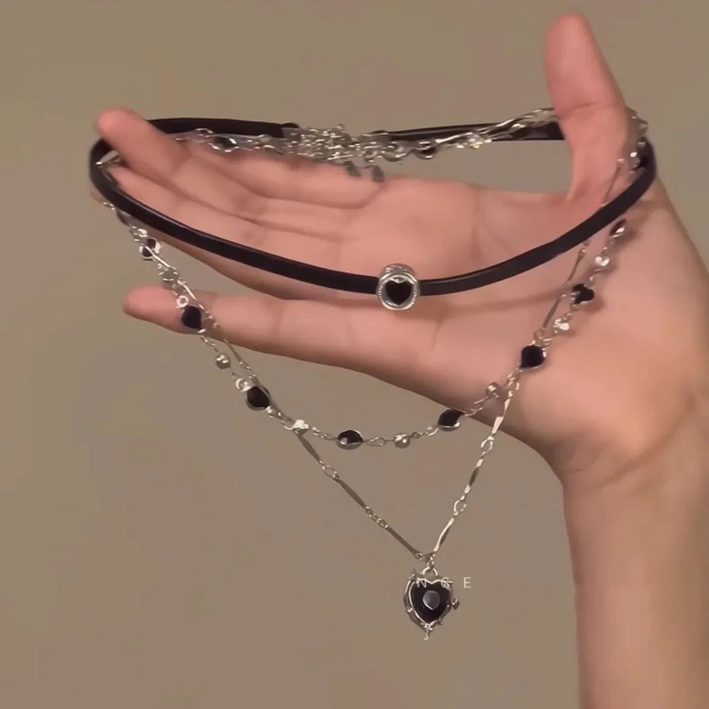 Women's twin-layer necklace with a leather-wrapped heart-shaped alloy pendant on an adjustable chain.