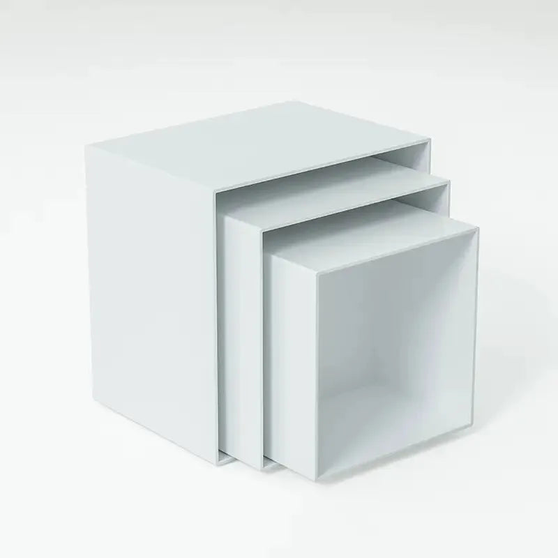 White plastic modular cube set assembled as a tiered desktop dessert display stand.