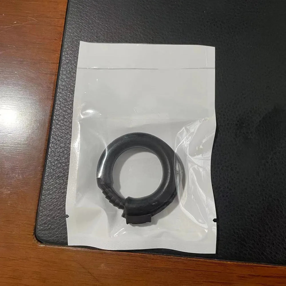 Silicone delayed ejaculation men's ring in black colour on a plain background