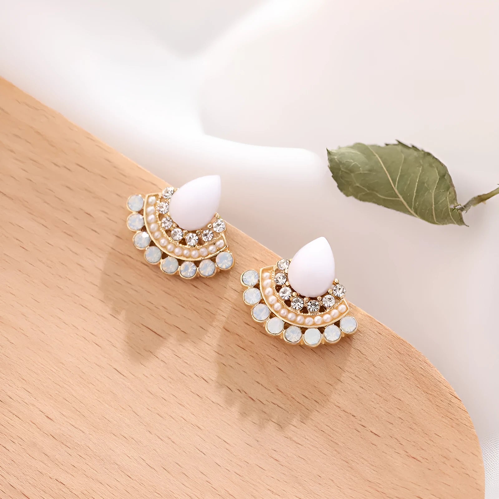 Women's retro fan-shaped silver stud earrings with rhinestones on a geometric alloy design.